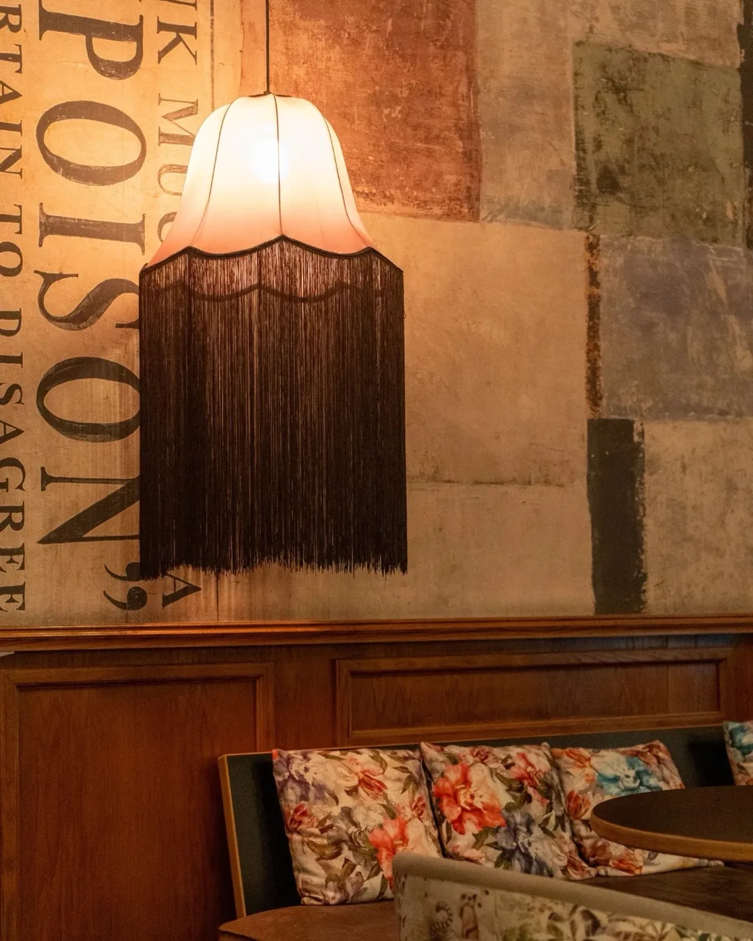 Fringed lamps and velvet sofa